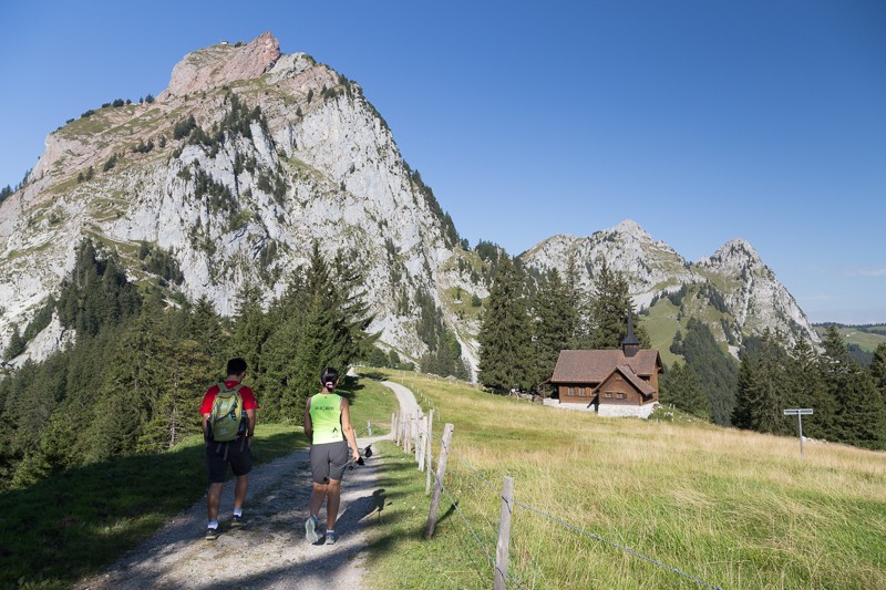 Peu avant la Holzegg, la chapelle semble minuscule à côté de l’imposant Mythen. Le chemin passe ici sur une petite route alpestre puis sur un étroit sentier. Photo: Markus Ruff